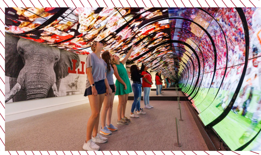 Students watch a video on a large curved screen in the welcome center